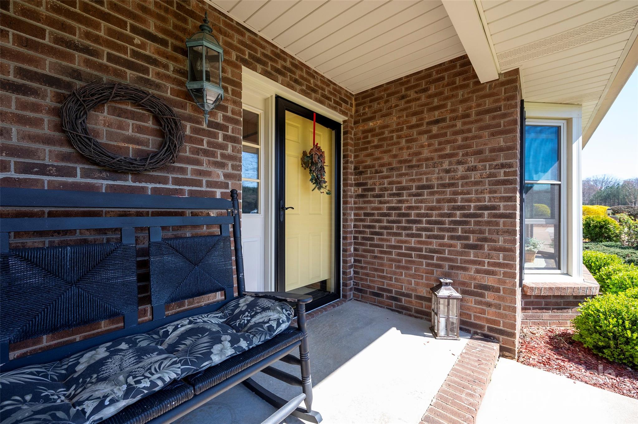 1120 Fred Merritt Road King, NC 27021 - Photo 17 of 45 a brick building with a bench and potted plant