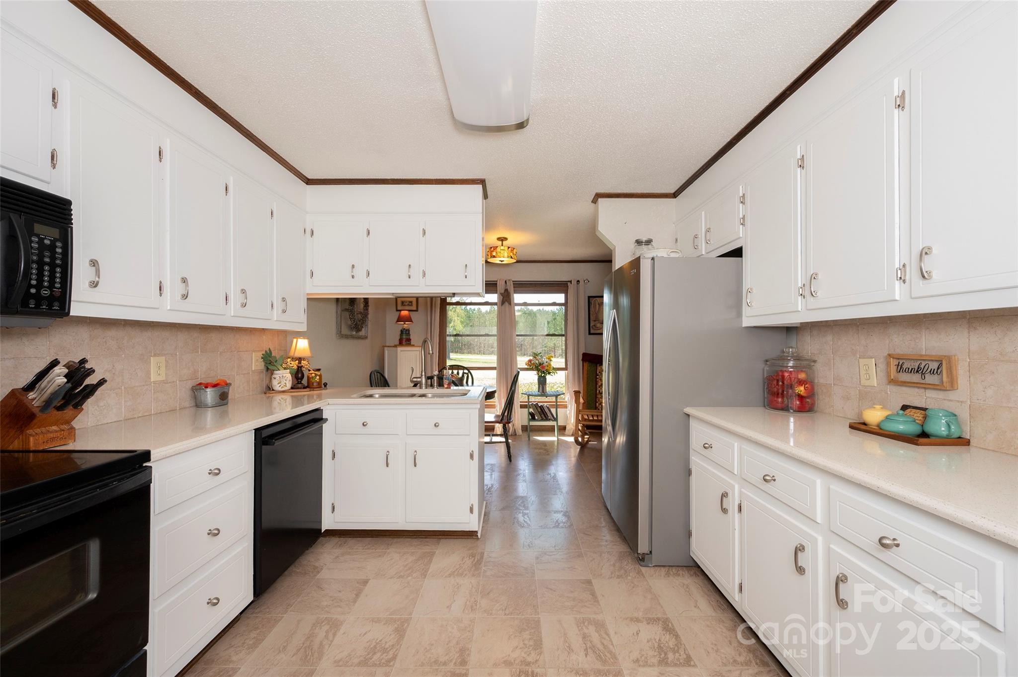 1120 Fred Merritt Road King, NC 27021 - Photo 24 of 45 a kitchen with white cabinets and white appliances