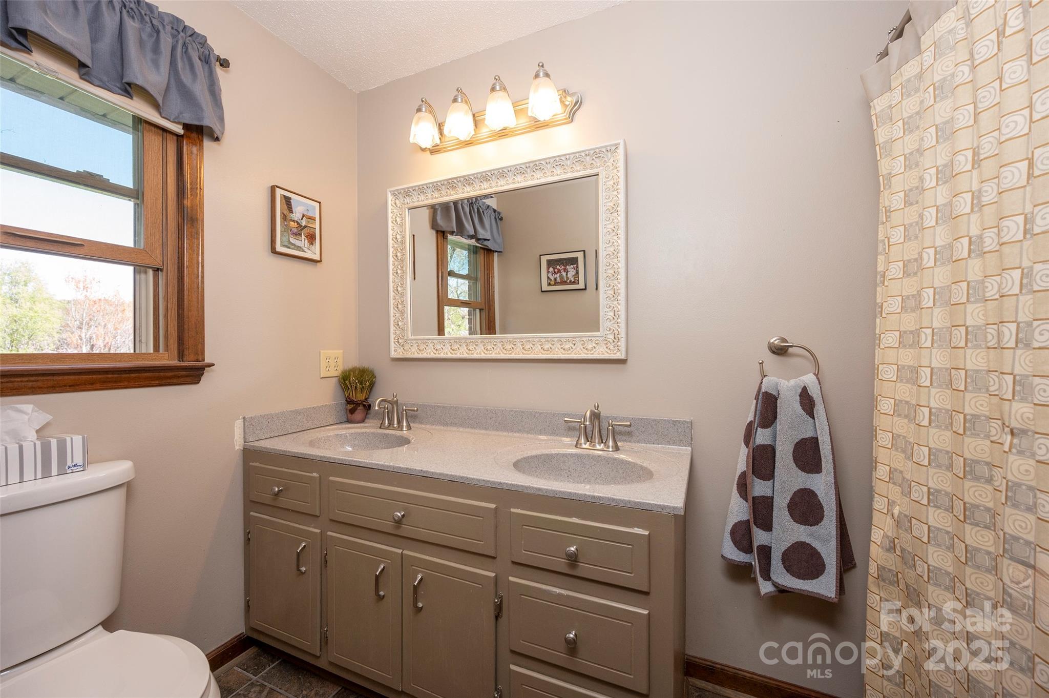 1120 Fred Merritt Road King, NC 27021 - Photo 29 of 45 a bathroom with a sink and a mirror