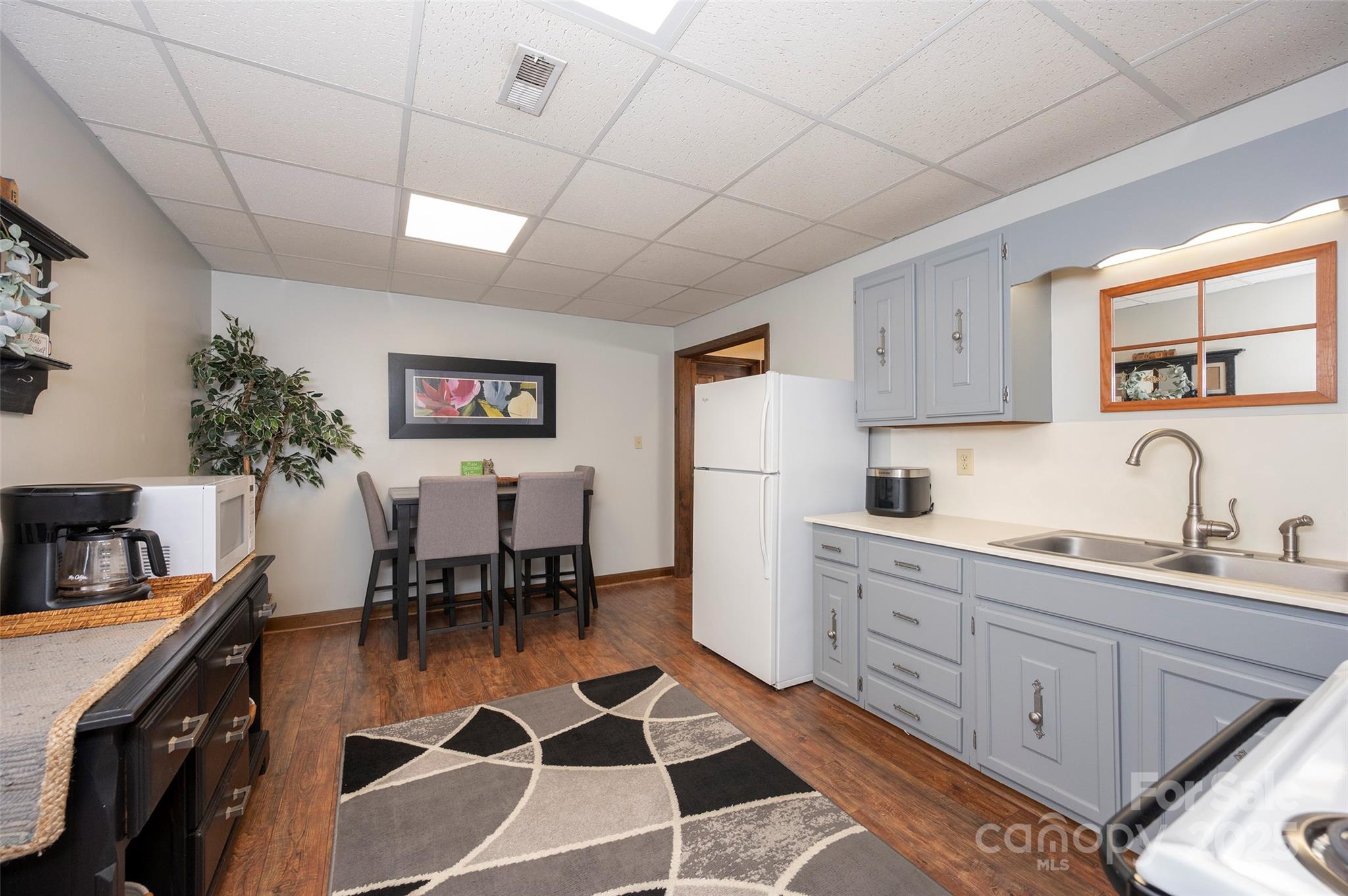 1120 Fred Merritt Road King, NC 27021 - Photo 34 of 45 a kitchen with a dining table chairs and white appliances