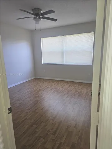 a view of room with window and hardwood floor