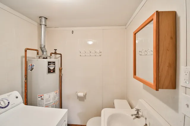 a bathroom with a sink a toilet and shower curtain