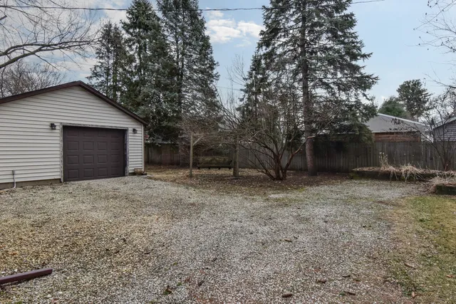 a view of a house with a yard and garage