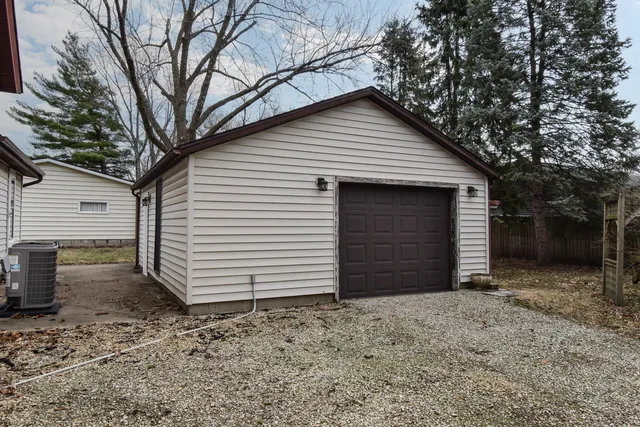 a view of a house with a yard and garage