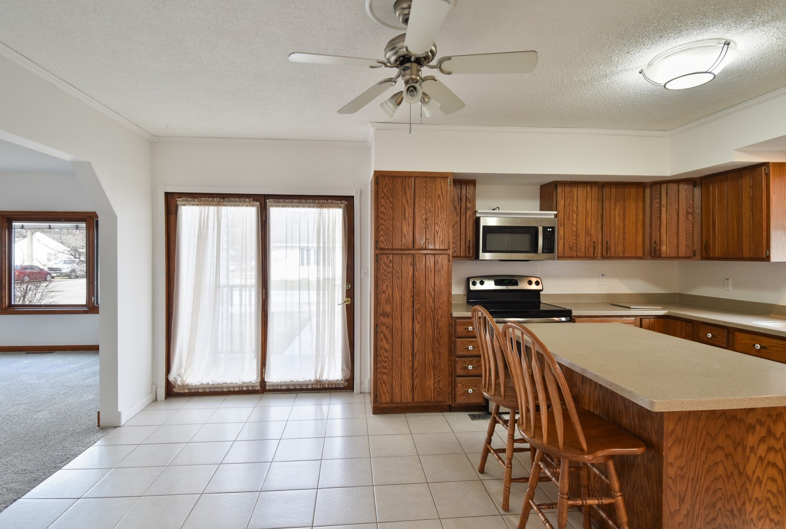 301 East Douglas Street St. Joseph, IL 61873 - Photo 7 of 38 a kitchen with a refrigerator a stove a microwave oven cabinets and a dining table