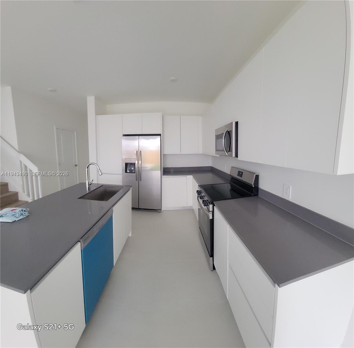 34493 Southwest 191st Court Homestead, FL 33034 - Photo 5 of 12 a kitchen with stainless steel appliances granite countertop a sink stove and refrigerator