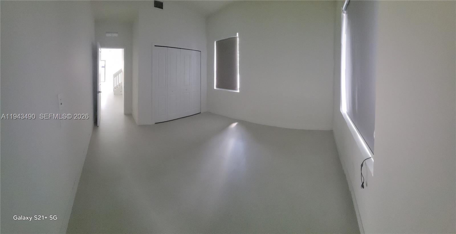 34493 Southwest 191st Court Homestead, FL 33034 - Photo 6 of 12 an empty room with wooden floor and windows