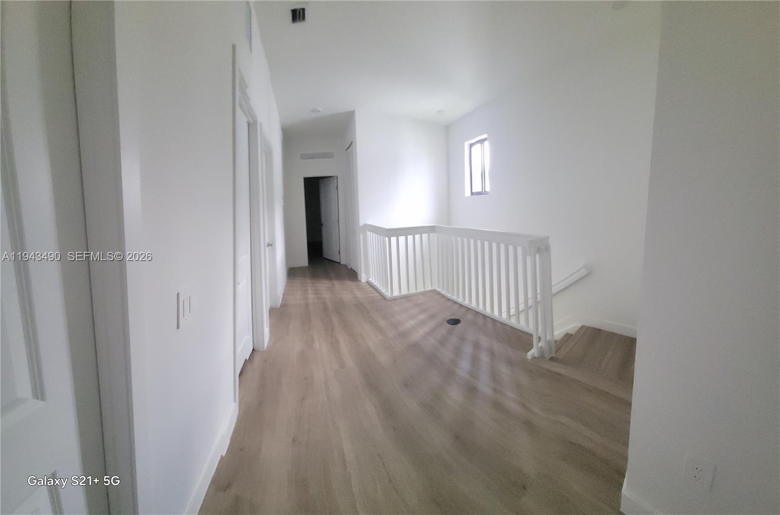 34493 Southwest 191st Court Homestead, FL 33034 - Photo 10 of 12 a view of a hallway with wooden floor and entryway
