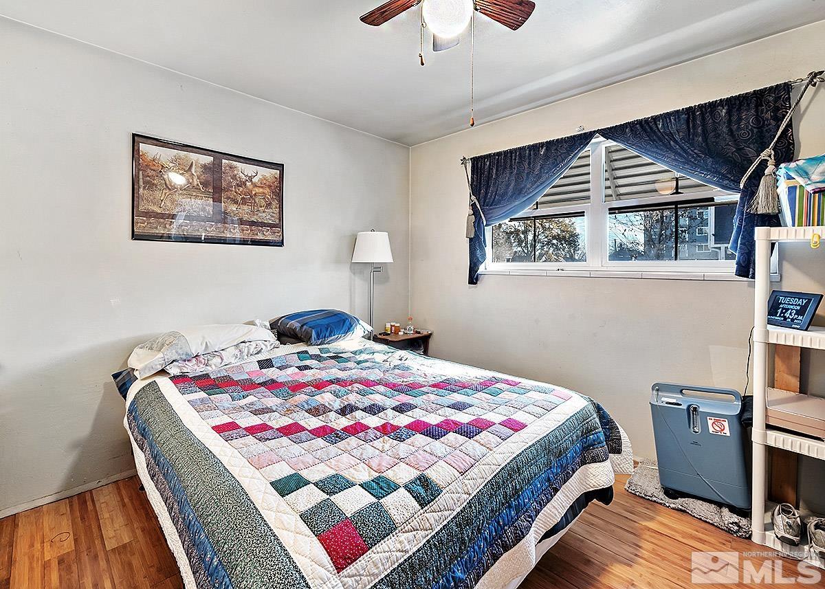 412 East 8th Street Reno, NV 89512 - Photo 14 of 40 a bedroom with a bed and a chandelier