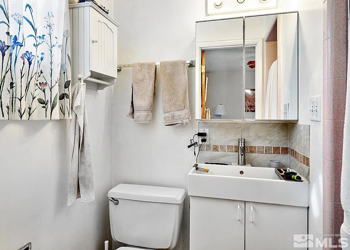 412 East 8th Street Reno, NV 89512 - Photo 15 of 40 a bathroom with a sink and mirror with toilet