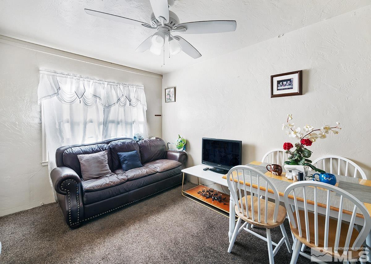412 East 8th Street Reno, NV 89512 - Photo 26 of 40 a living room with furniture a fireplace and a flat screen tv