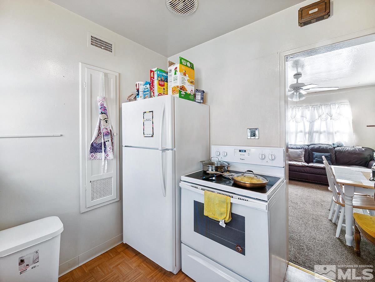 412 East 8th Street Reno, NV 89512 - Photo 27 of 40 a white refrigerator freezer and a stove sitting inside of a kitchen