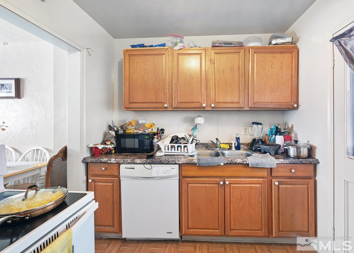 412 East 8th Street Reno, NV 89512 - Photo 28 of 40 a kitchen with stainless steel appliances granite countertop a sink stove and cabinets