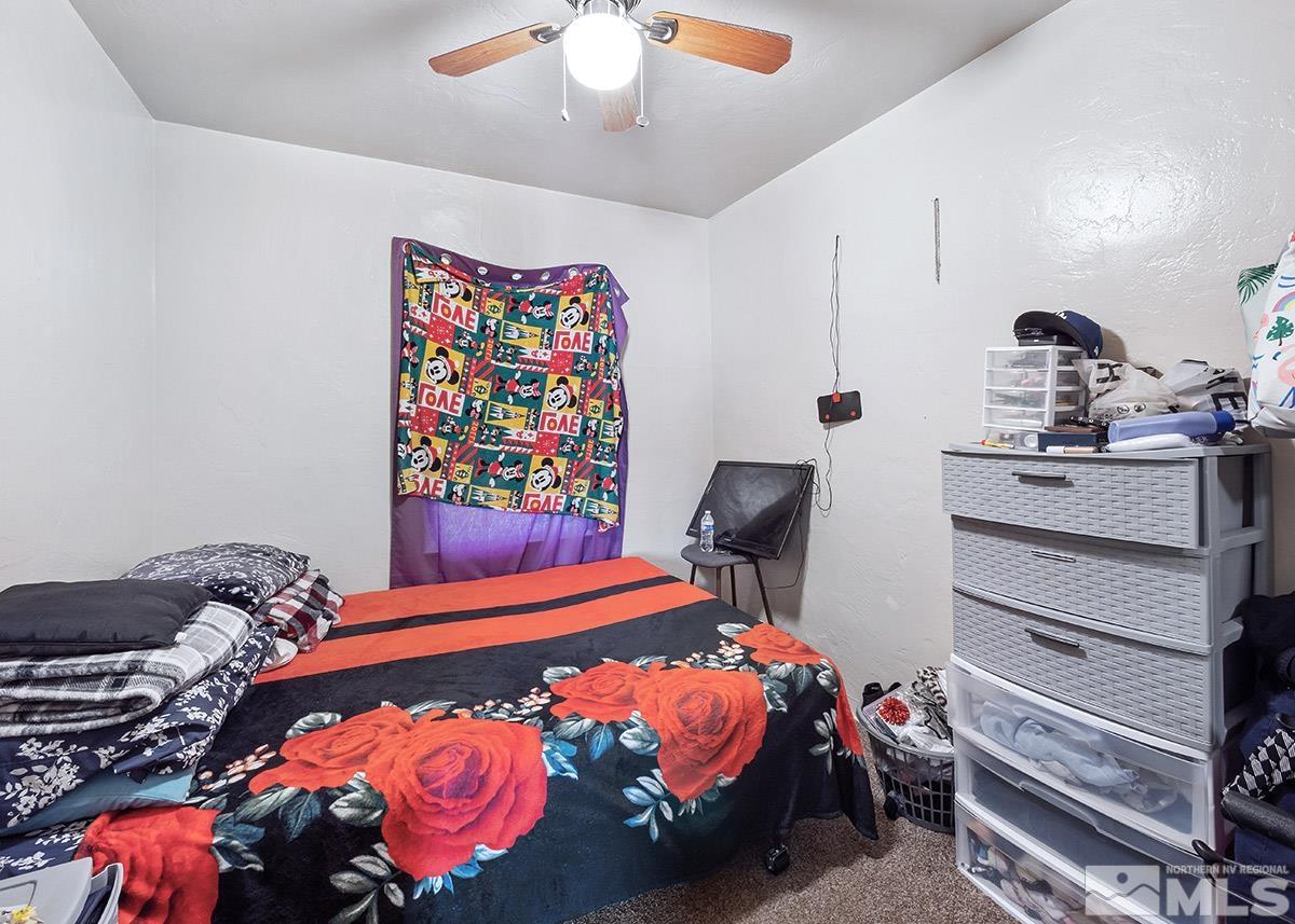412 East 8th Street Reno, NV 89512 - Photo 29 of 40 a bedroom with a bed and a chandelier