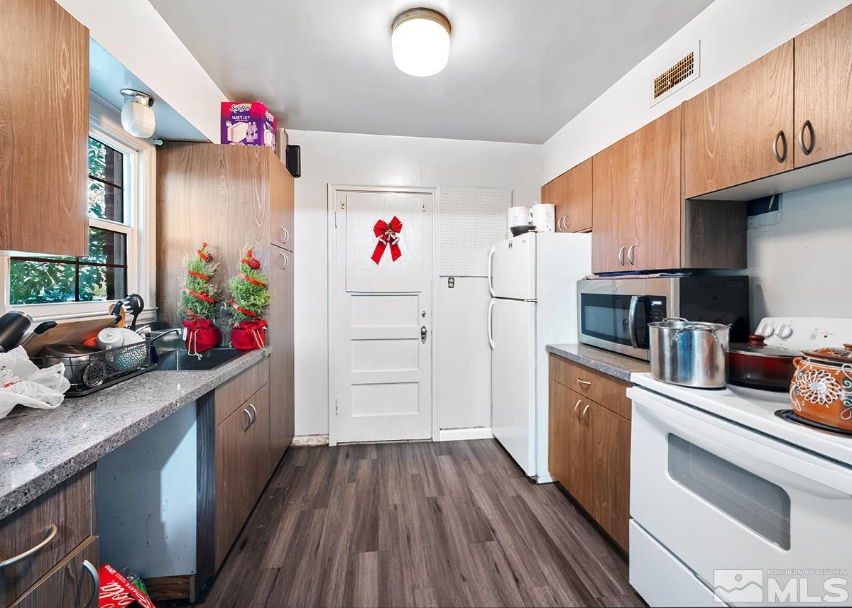 412 East 8th Street Reno, NV 89512 - Photo 36 of 40 a kitchen that has a lot of cabinets a sink and dishwasher
