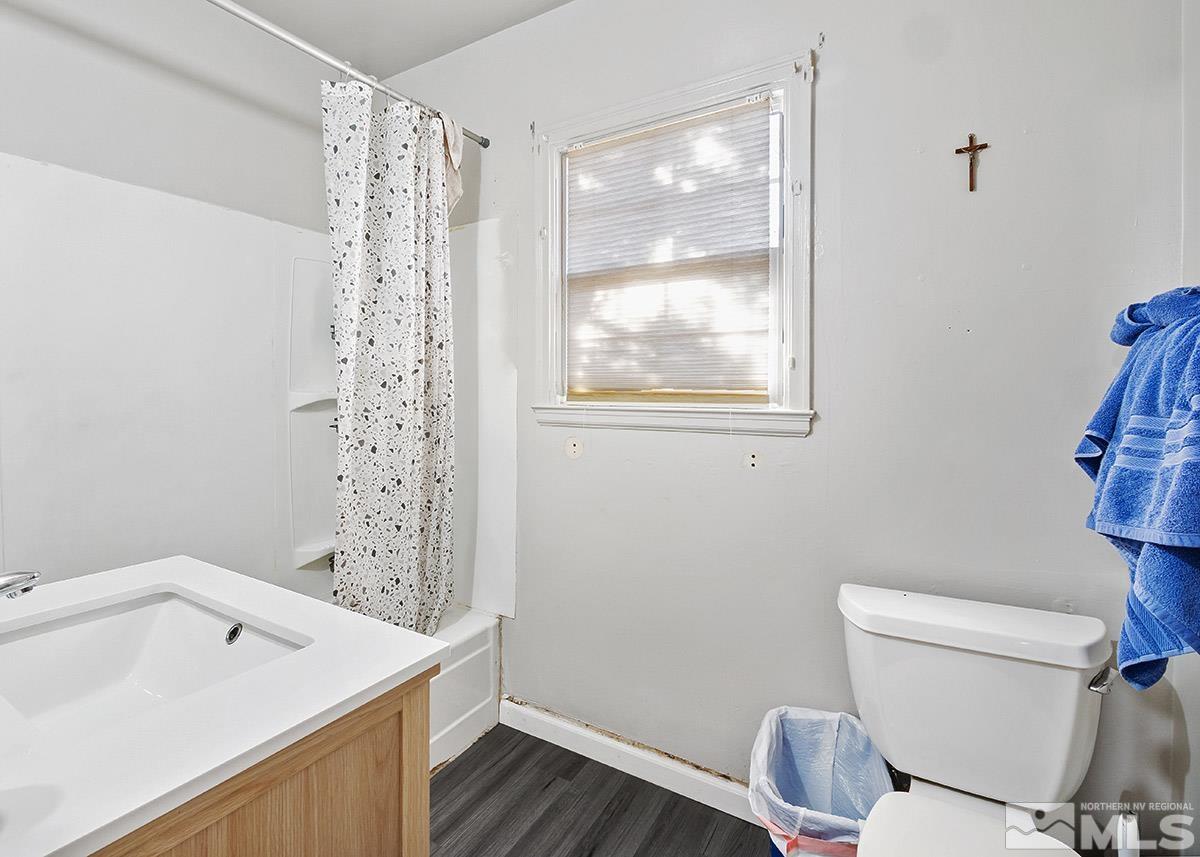 412 East 8th Street Reno, NV 89512 - Photo 37 of 40 a bathroom with a sink a toilet and a window