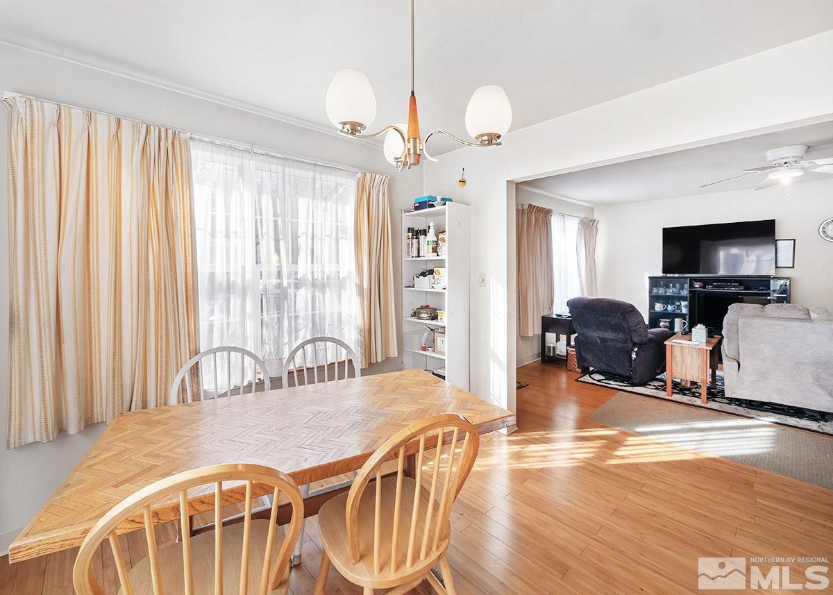 412 East 8th Street Reno, NV 89512 - Photo 8 of 40 a dining room with wooden floor furniture and a chandelier