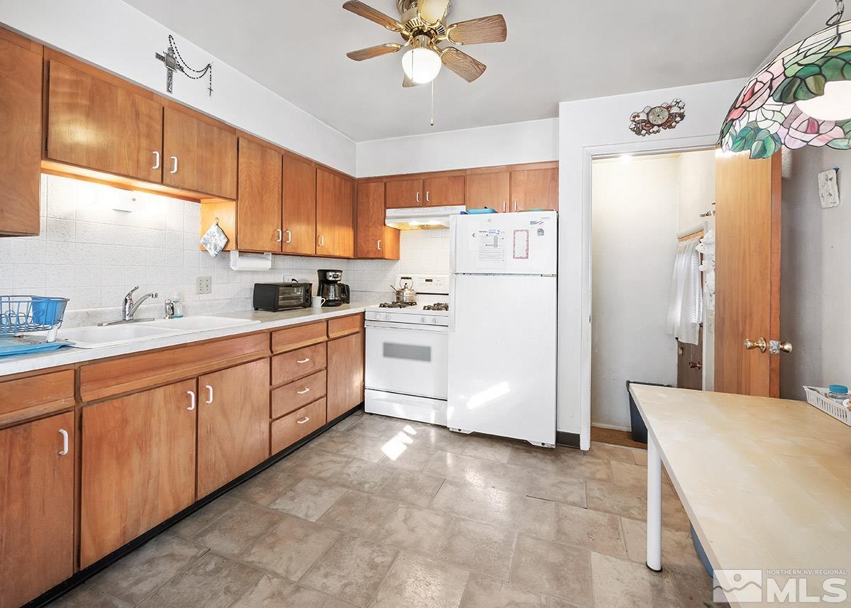 412 East 8th Street Reno, NV 89512 - Photo 9 of 40 a kitchen with a refrigerator a sink and cabinets