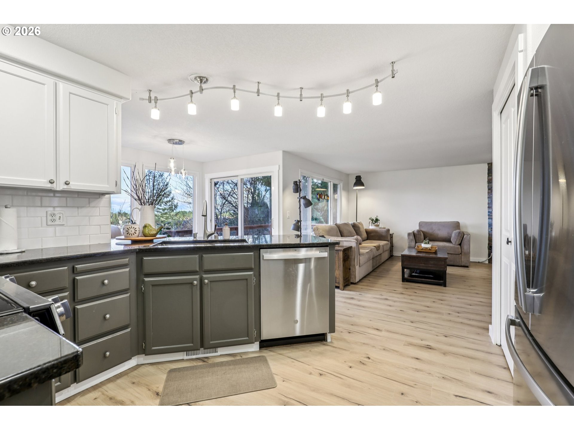 1702 Northeast 70th Street Vancouver, WA 98665 - Photo 14 of 32 a kitchen with stainless steel appliances kitchen island granite countertop a refrigerator and cabinets