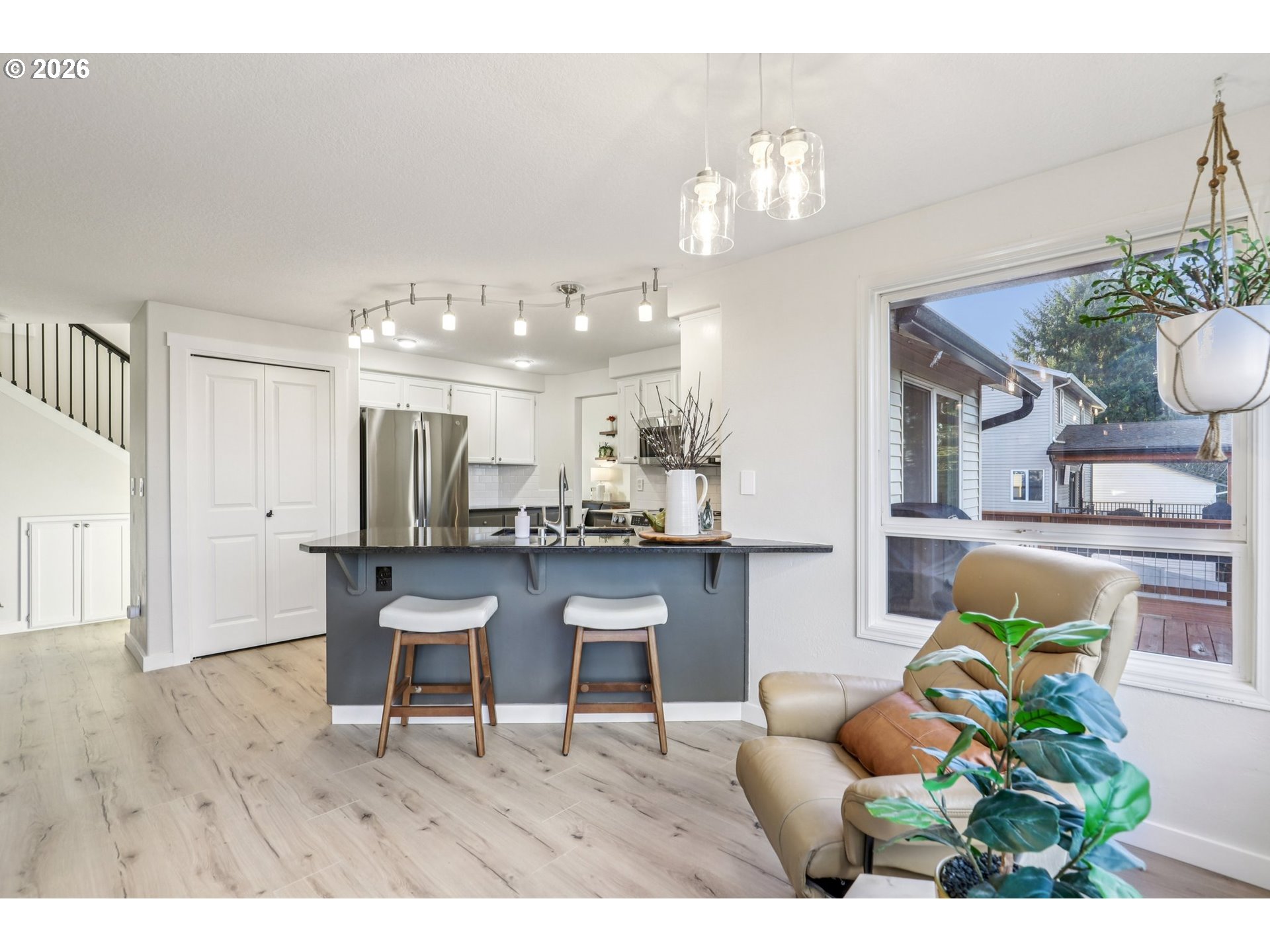 1702 Northeast 70th Street Vancouver, WA 98665 - Photo 17 of 32 a living room with furniture a chandelier and kitchen view
