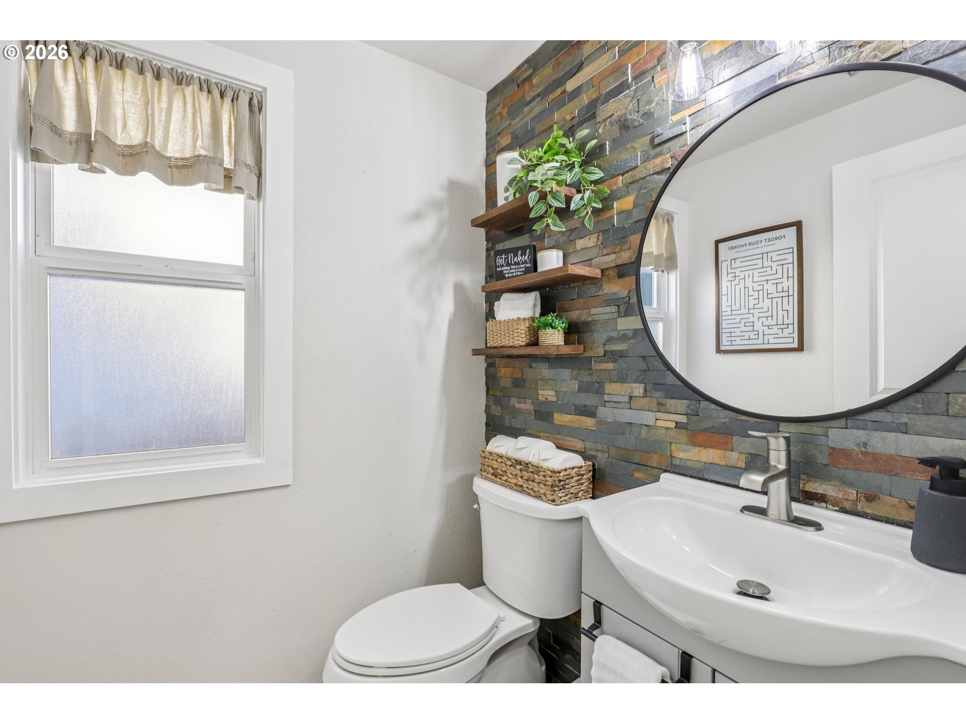 1702 Northeast 70th Street Vancouver, WA 98665 - Photo 19 of 32 a bathroom with a toilet a sink and mirror