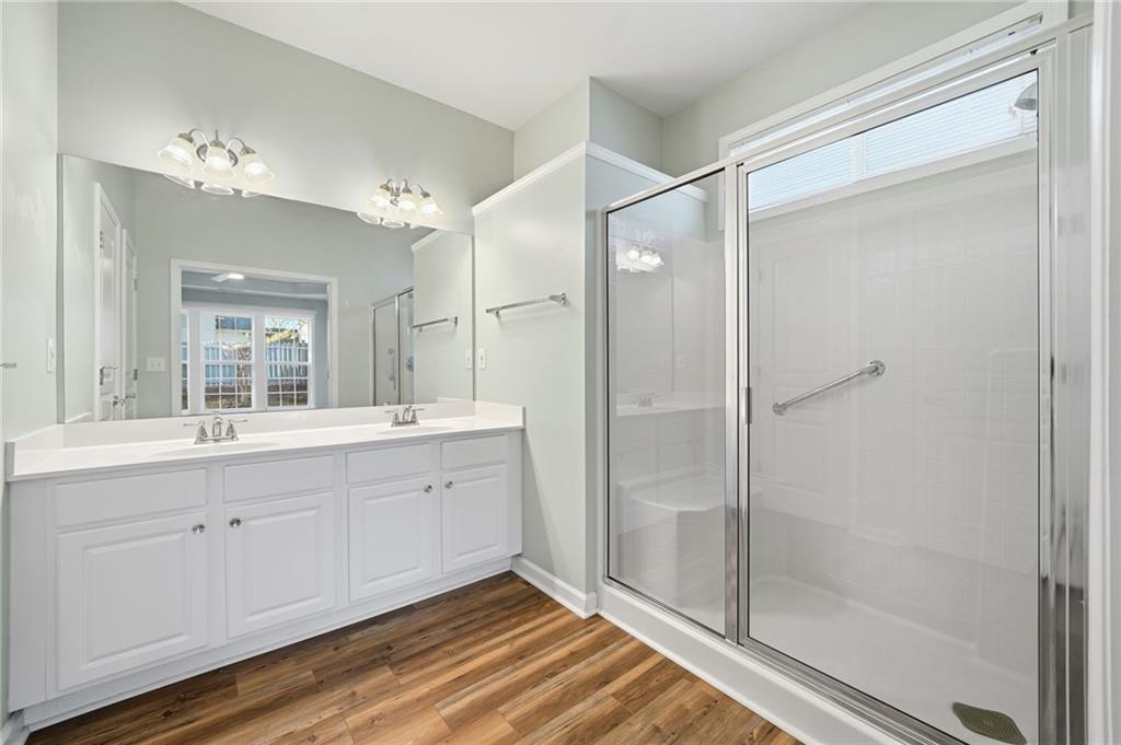 3901 Delfaire Trace Cumming, GA 30040 - Photo 34 of 45 a spacious bathroom with a shower sink and mirror