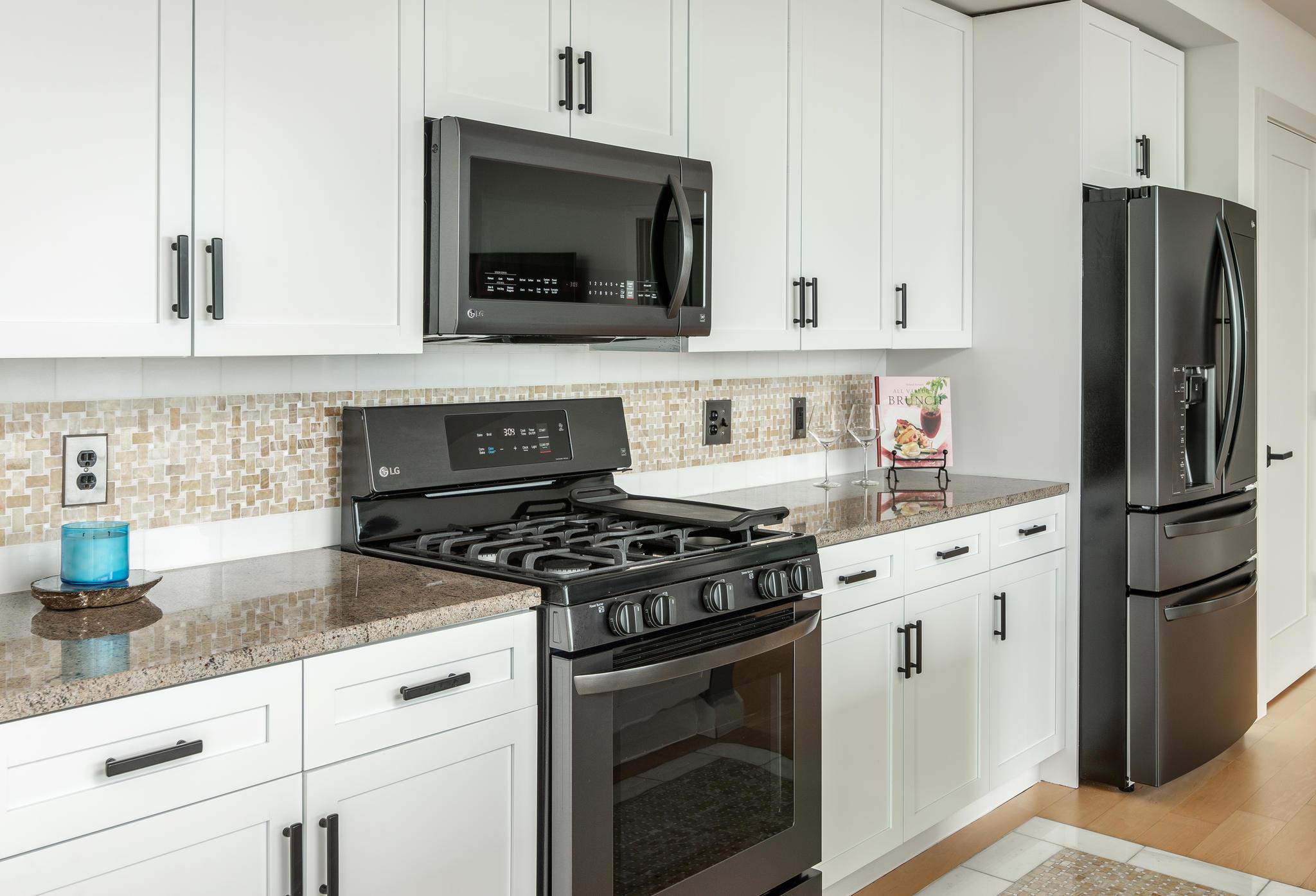 900 20th Avenue South, Unit 1001 Nashville, TN 37212 - Photo 6 of 30 a kitchen with cabinets stainless steel appliances and wooden floor