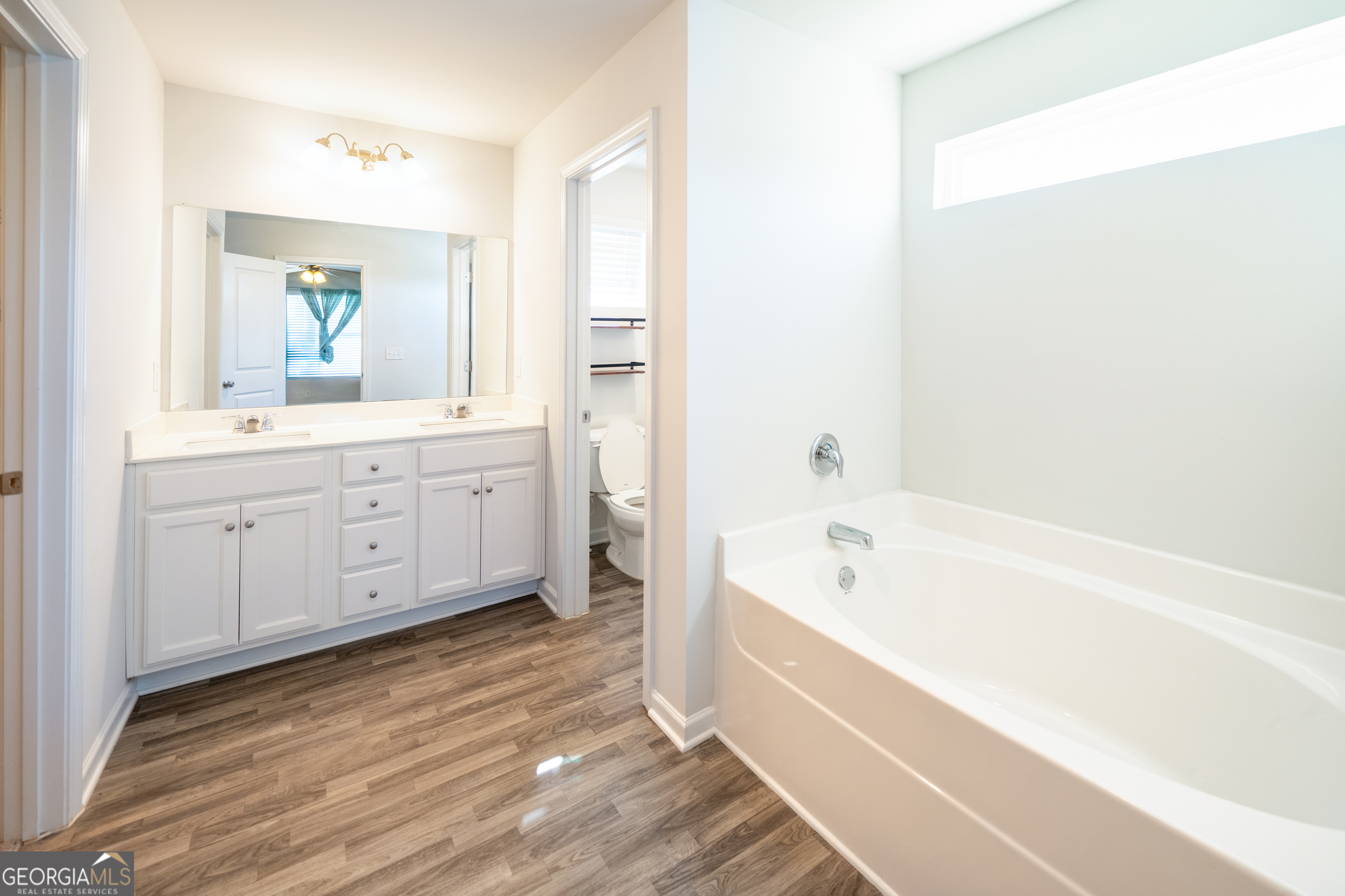 132 Fresh Laurel Lane Locust Grove, GA 30248 - Photo 22 of 24 a spacious bathroom with a tub sink and mirror
