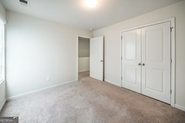 a view of an empty room and closet area