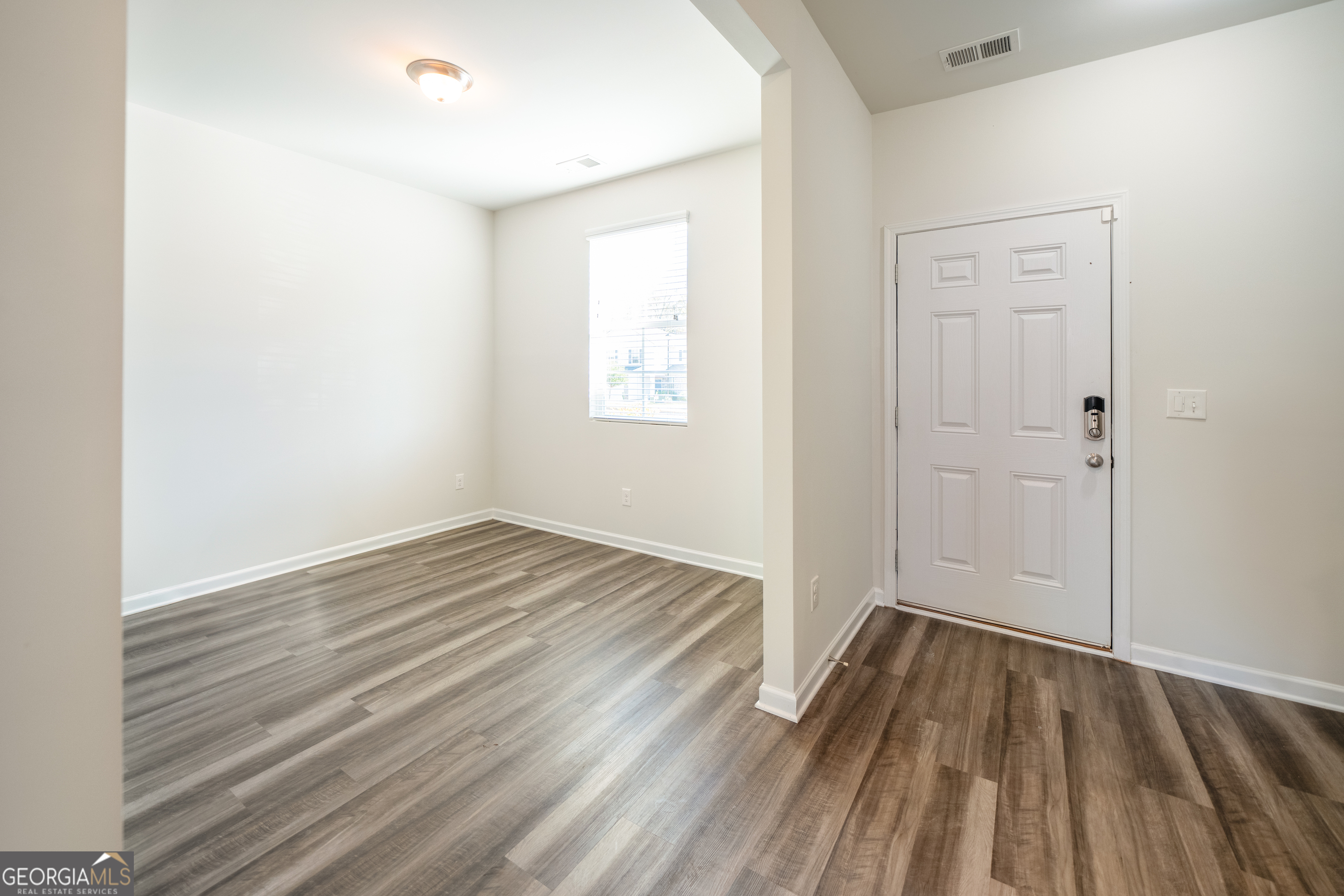 132 Fresh Laurel Lane Locust Grove, GA 30248 - Photo 9 of 24 wooden floor in an empty room with a window