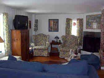 12 Glendale Road Stockbridge, MA 01229 - Photo 2 of 2 a living room with furniture a fireplace and a flat screen tv