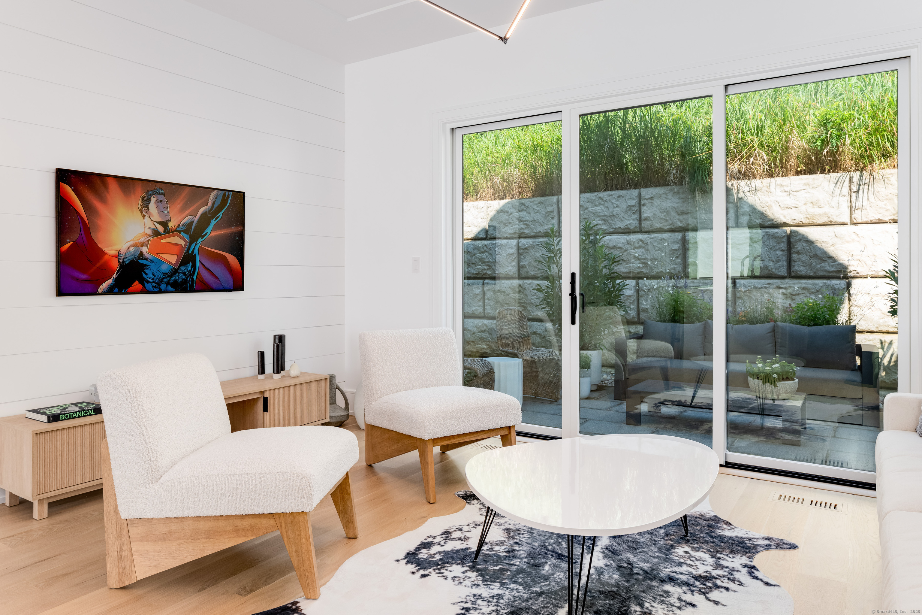a living room with furniture a lamp and a potted plant