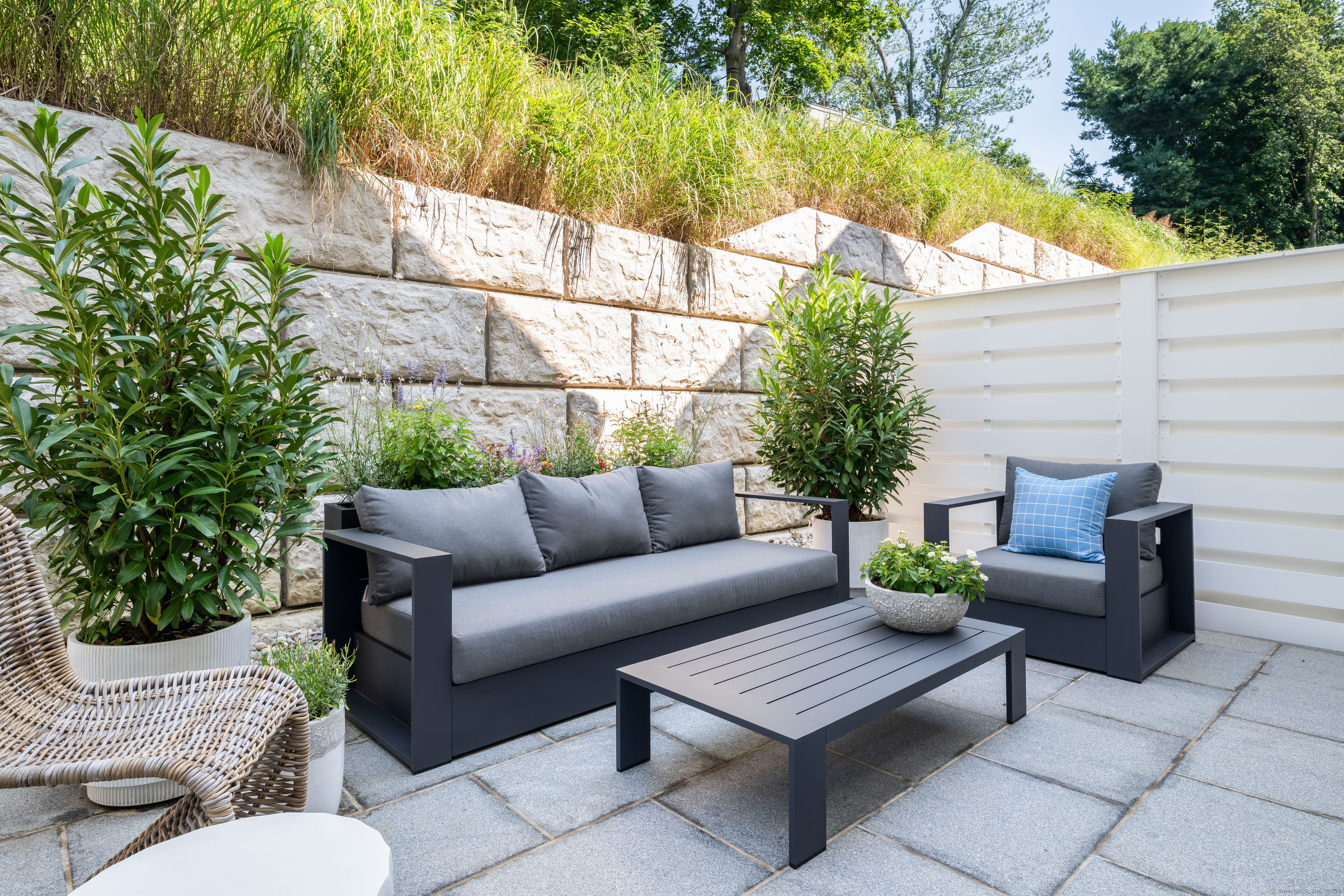 785 Post Road East, Unit 302 Westport, CT 06880 - Photo 15 of 39 a view of a patio with couches table and chairs and potted plants