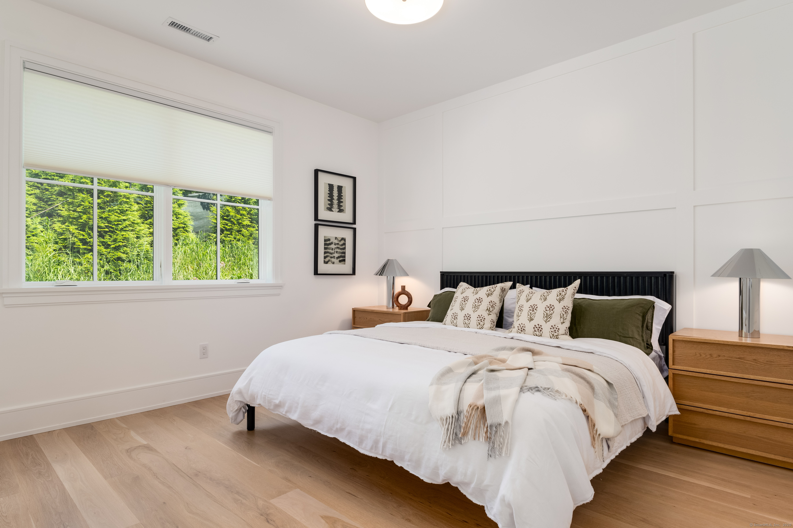 785 Post Road East, Unit 302 Westport, CT 06880 - Photo 18 of 39 a bed sitting in a bedroom next to a window