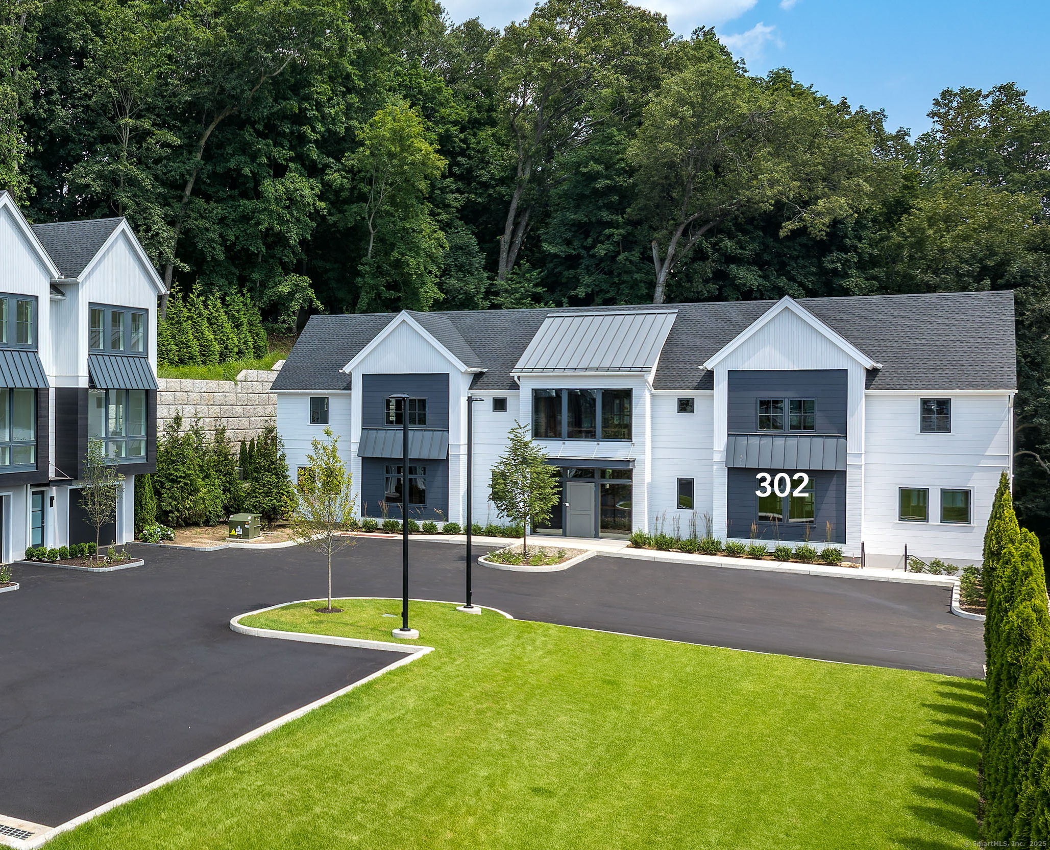 785 Post Road East, Unit 302 Westport, CT 06880 - Photo 2 of 39 a front view of a house with yard and green space