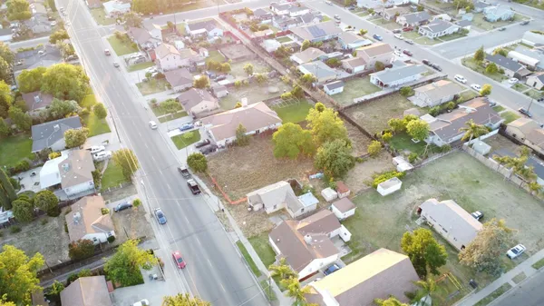 an aerial view of a house with a yard