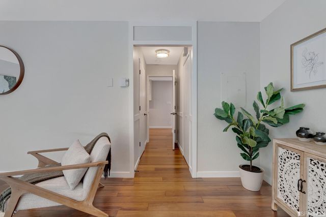 a view of a dining room with furniture and wooden floor