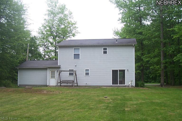 1532 North County Line Road Geneva, OH 44041 - Photo 7 of 22 Showing back of home, has cement patio off sliders for grill and furniture.