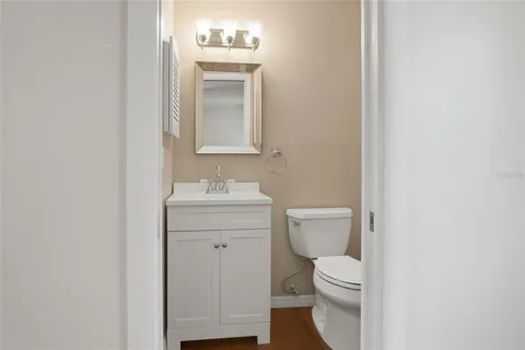a bathroom with a toilet a sink and mirror