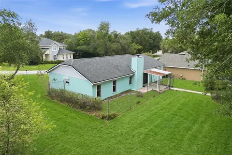 an aerial view of a house with a big yard