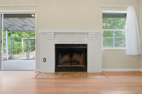 a living room with a fireplace and a floor to ceiling window