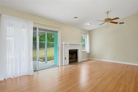 wooden floor fireplace and natural light in room