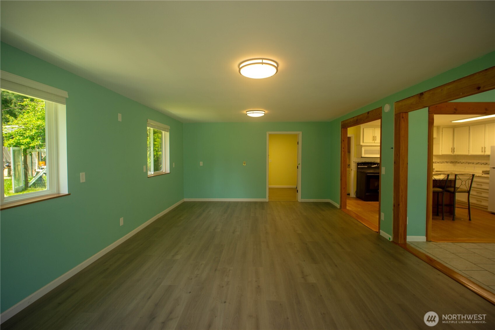 89 Slab Camp Road Sequim, WA 98382 - Photo 9 of 40 a view of an empty room with window and wooden floor