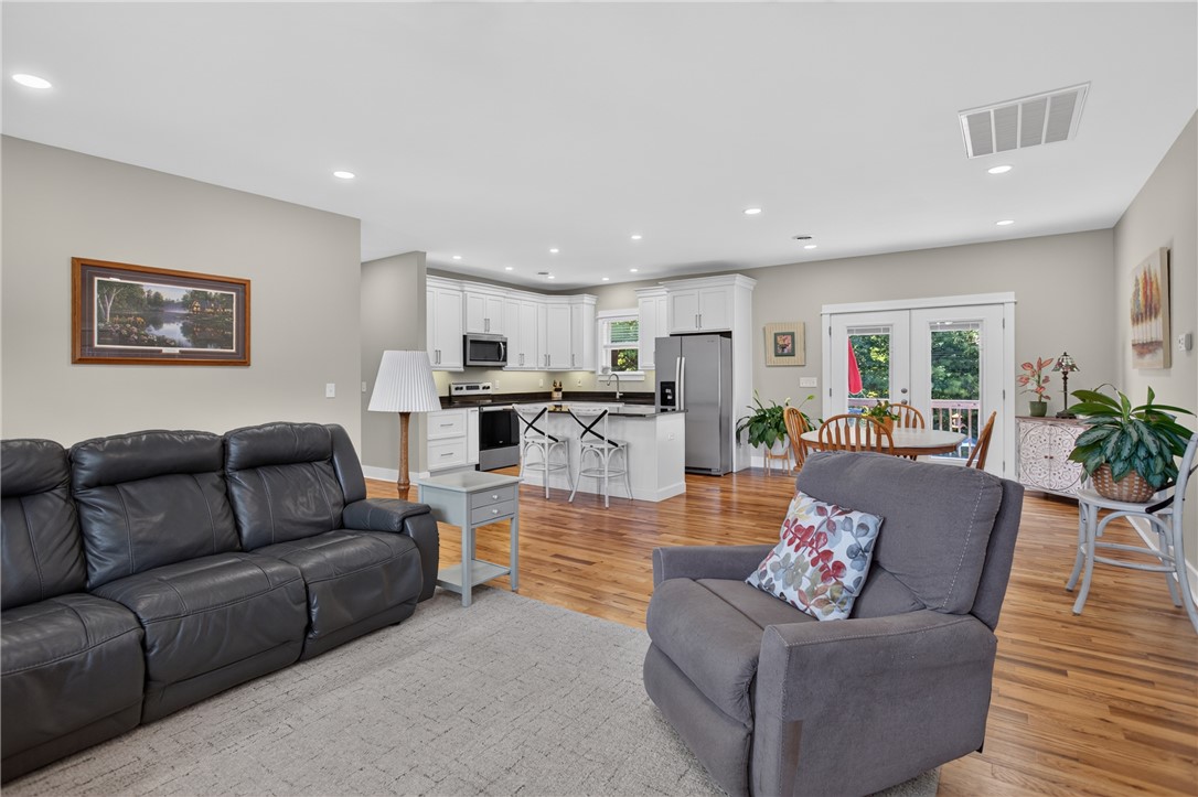 405 Pawnee Drive Walhalla, SC 29691 - Photo 35 of 36 An open floorplan seamlessly connects the living area, kitchen, and dining space with rich hardwood flooring.