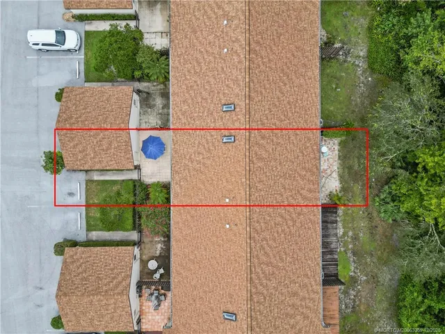 an aerial view of a house with a yard
