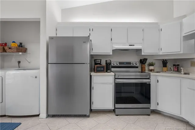 a kitchen with cabinets and stainless steel appliances
