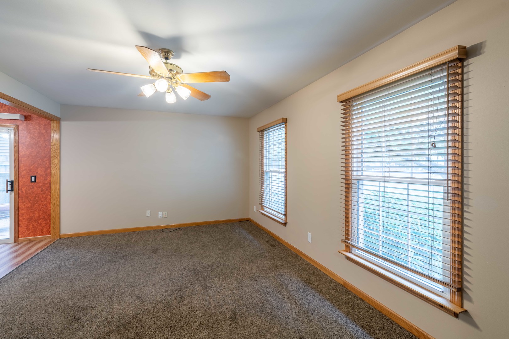215 Fernwood Road Montgomery, IL 60538 - Photo 2 of 18 an empty room with windows and fan