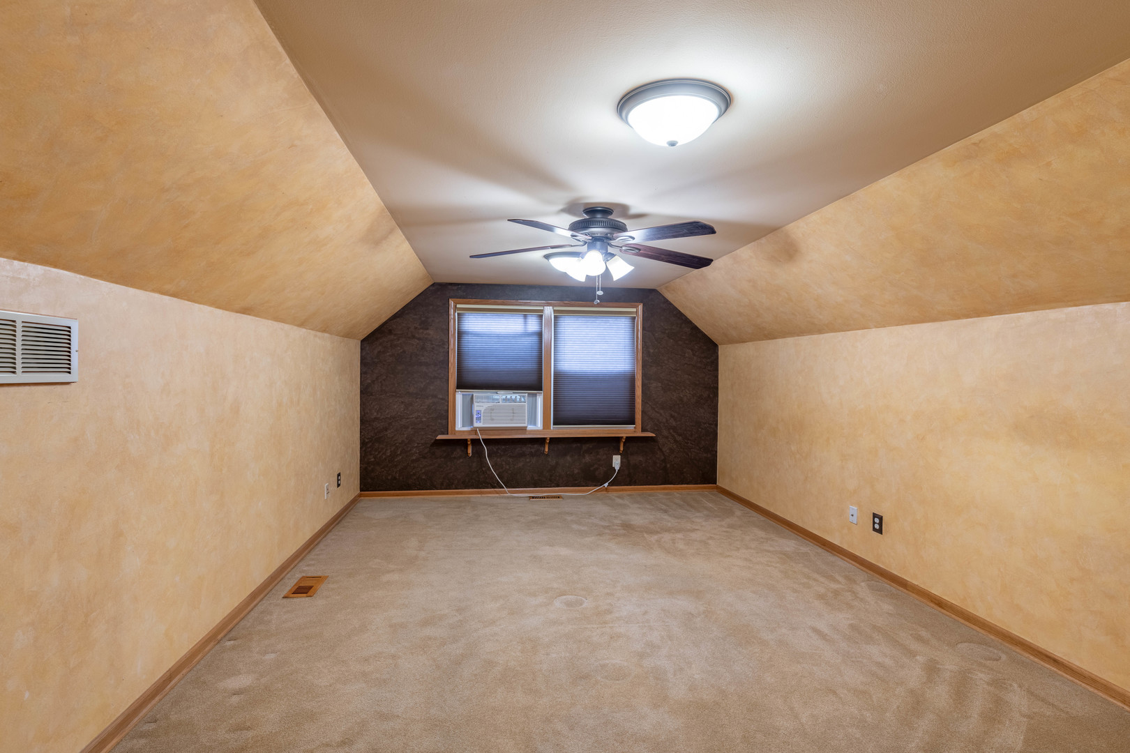 215 Fernwood Road Montgomery, IL 60538 - Photo 14 of 18 an empty room with a chandelier fan and windows