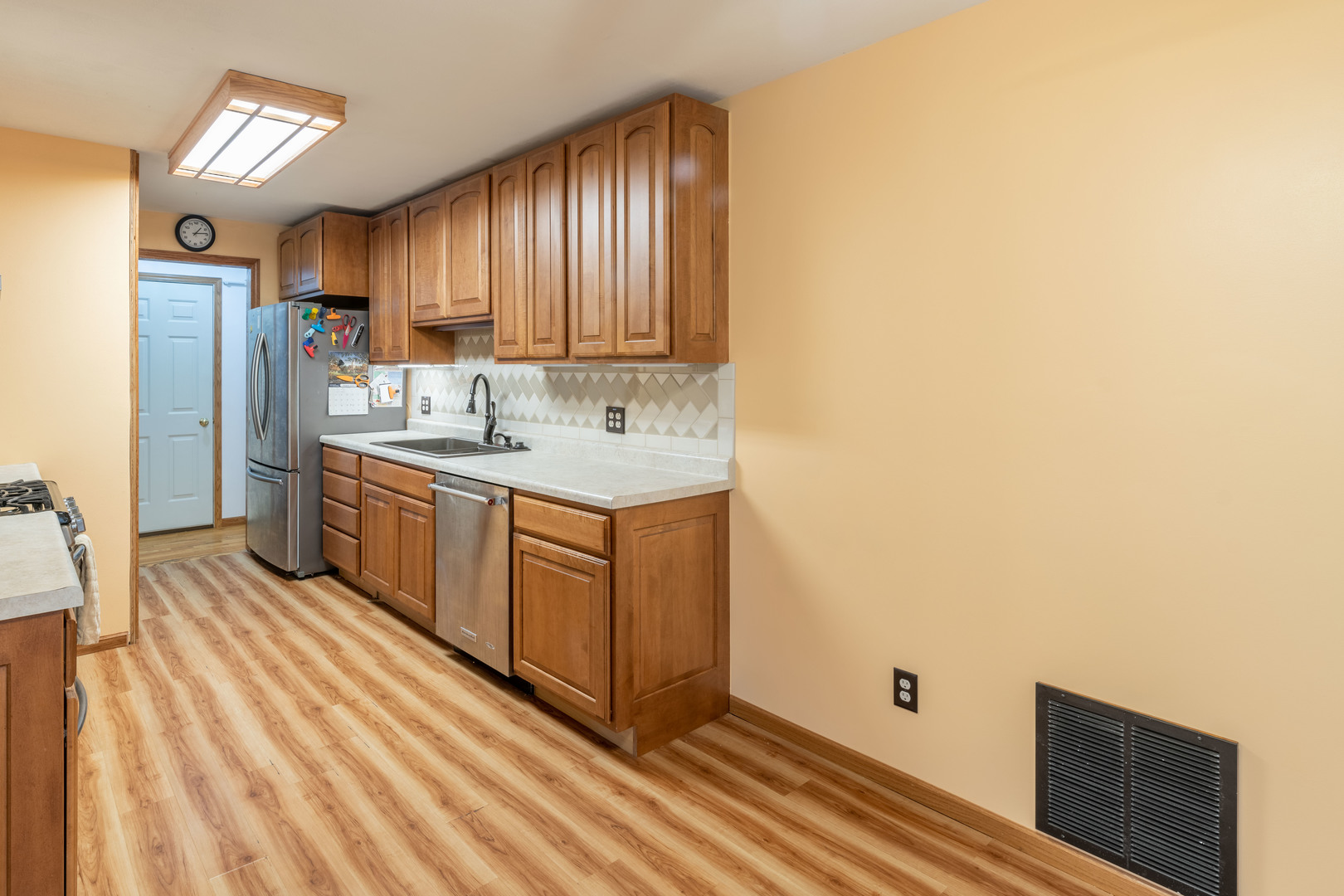 215 Fernwood Road Montgomery, IL 60538 - Photo 3 of 18 a kitchen with stainless steel appliances granite countertop a sink a stove and refrigerator