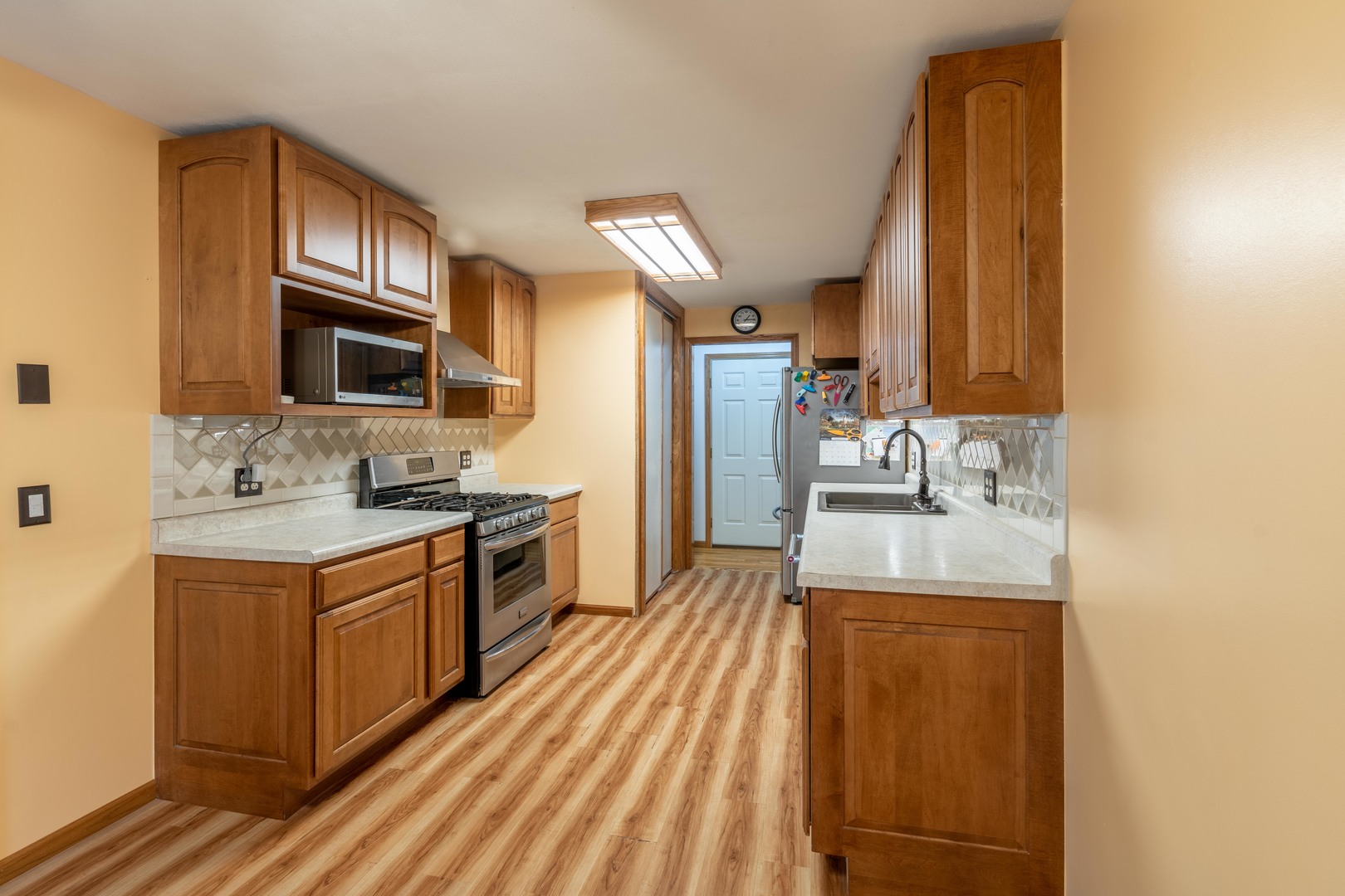 215 Fernwood Road Montgomery, IL 60538 - Photo 4 of 18 a kitchen with a sink stove and cabinets